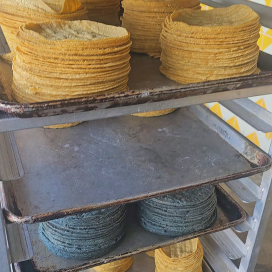 Watch stacks of organic blue and yellow corn tortillas cooling after being handmade at Grano Tortillería. Fresh, handmade, and delivered across California.

